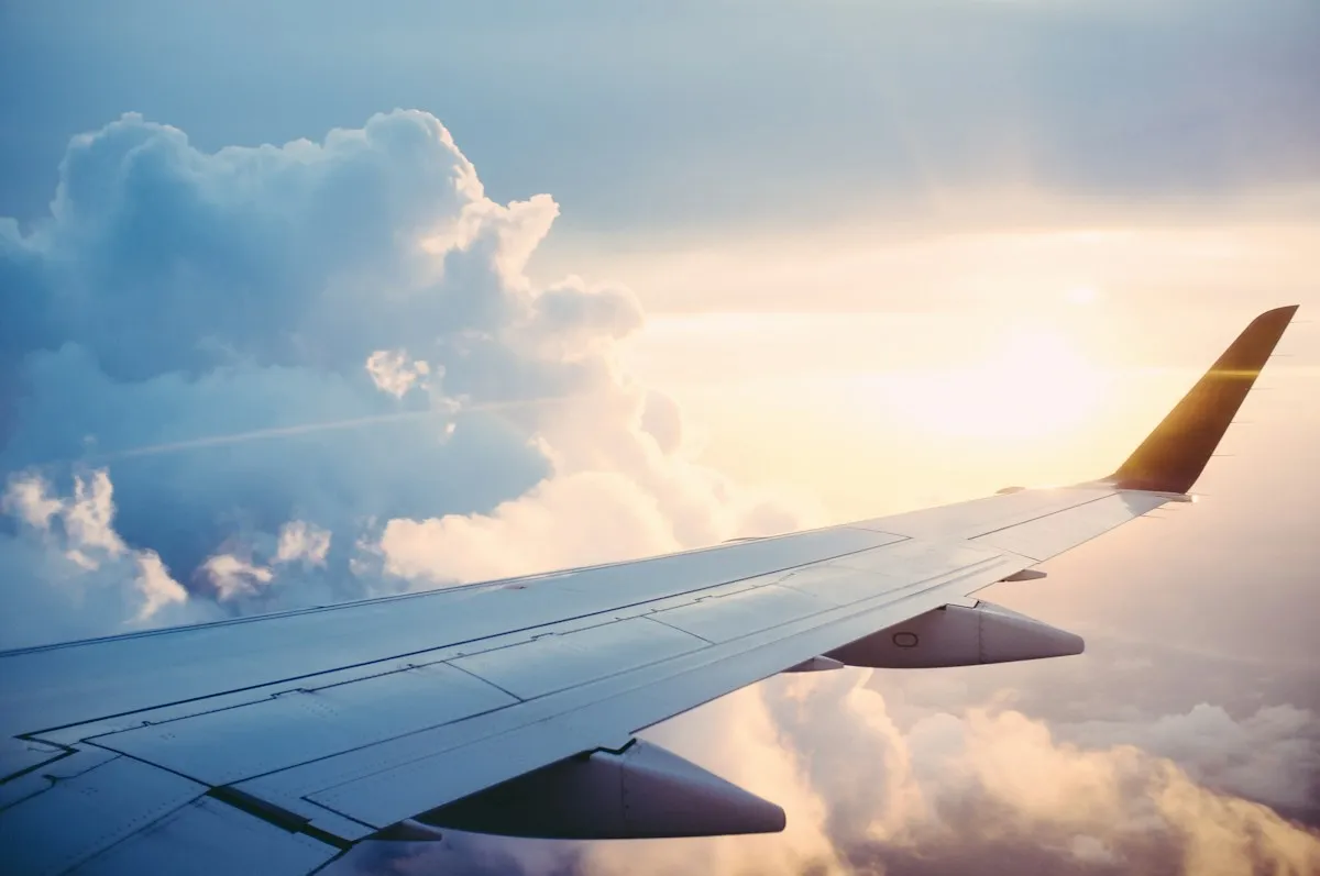 Aircraft wing above the clouds during an international flight